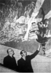 Joseph L. Lawrence and David K. Edwards, owners and operators of the Villa Theater look at one of the huge and attractive wall lighting decorations put in by Artistic Lighting.