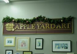 'Apple Yard Art' sign above the store's counter