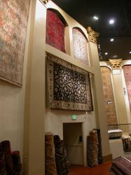 Three smaller rugs hang over the left exit by the stage, Adib's Rug Gallery at the former Villa Theatre, Salt Lake City, Utah